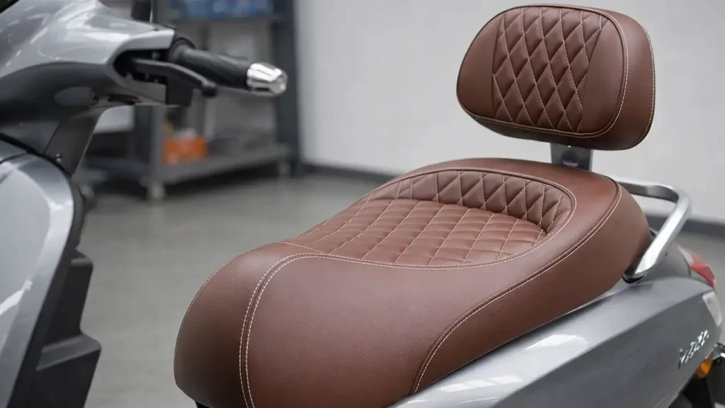 Close-up of a wide, comfortable scooter seat with back support